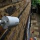 a cctv camera fitted to a house watching alleyway